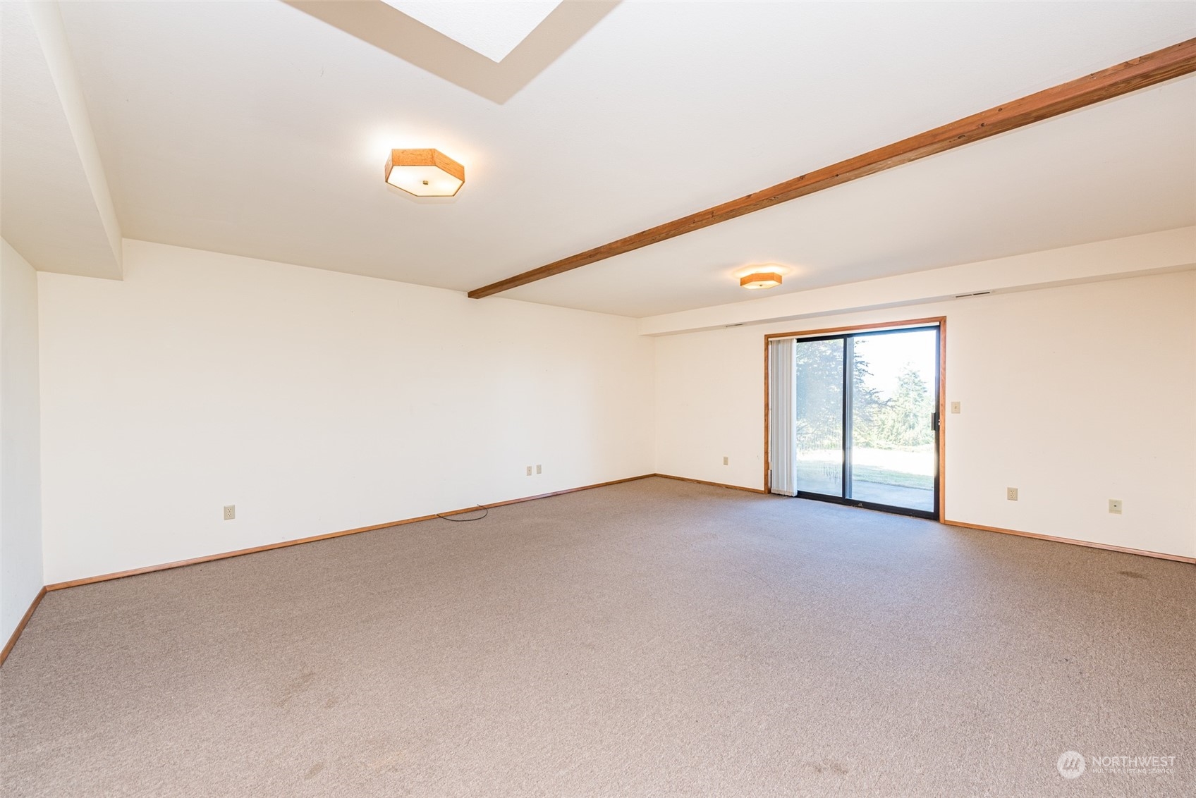 773 Ravens Ridge Road Sequim, WA 98382 - Photo 23 of 38 an empty room with a projector and windows