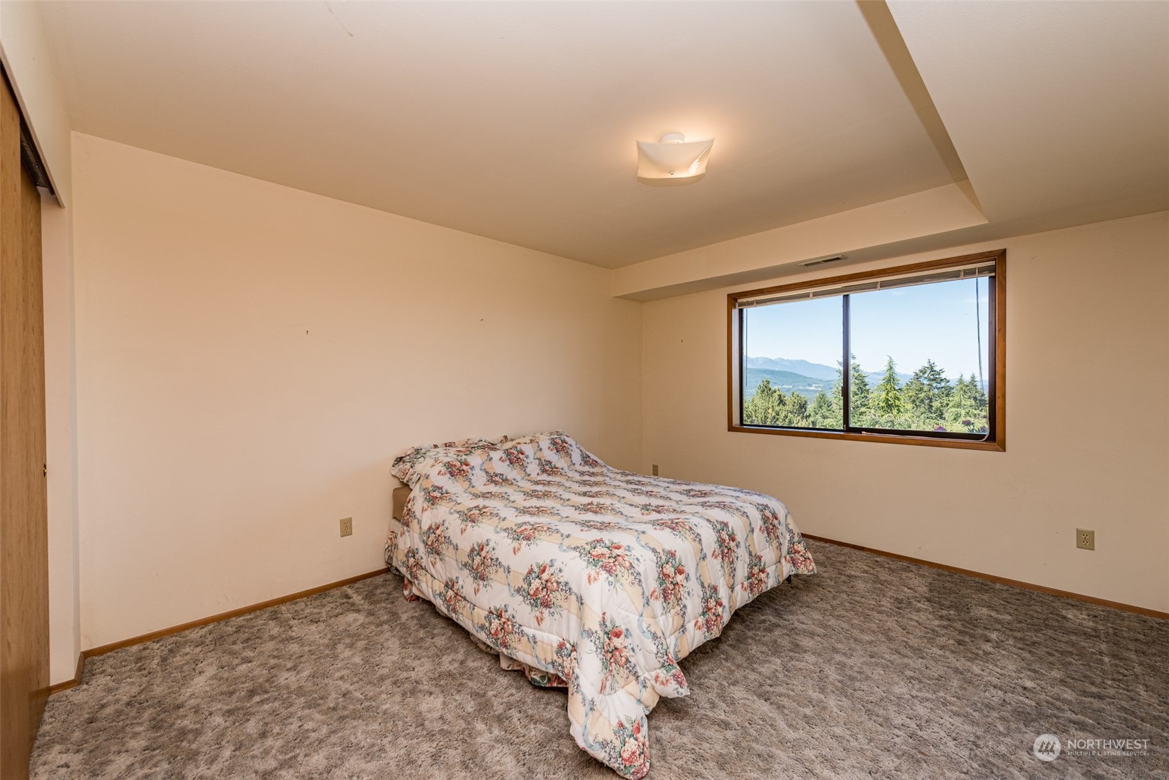 773 Ravens Ridge Road Sequim, WA 98382 - Photo 27 of 38 a bedroom with a bed and a window