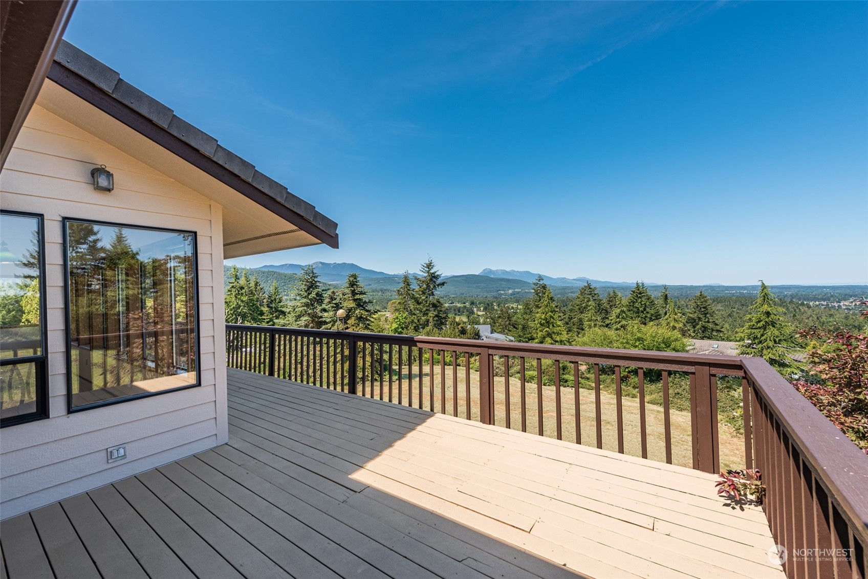 773 Ravens Ridge Road Sequim, WA 98382 - Photo 9 of 38 a balcony with wooden floor and fence