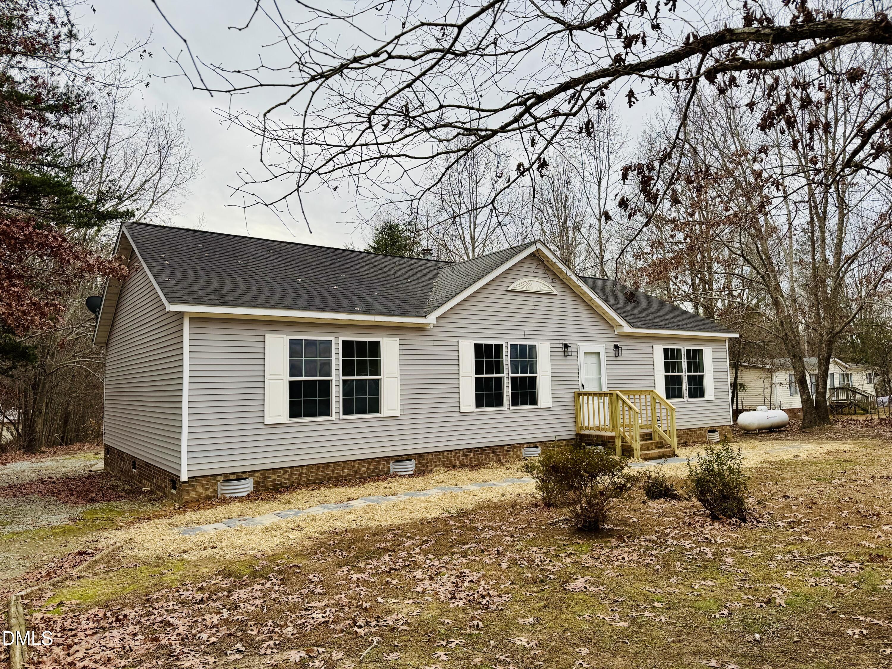 73 Christys Way Roxboro, NC 27574 - Photo 2 of 13 a front view of house with yard covered in snow