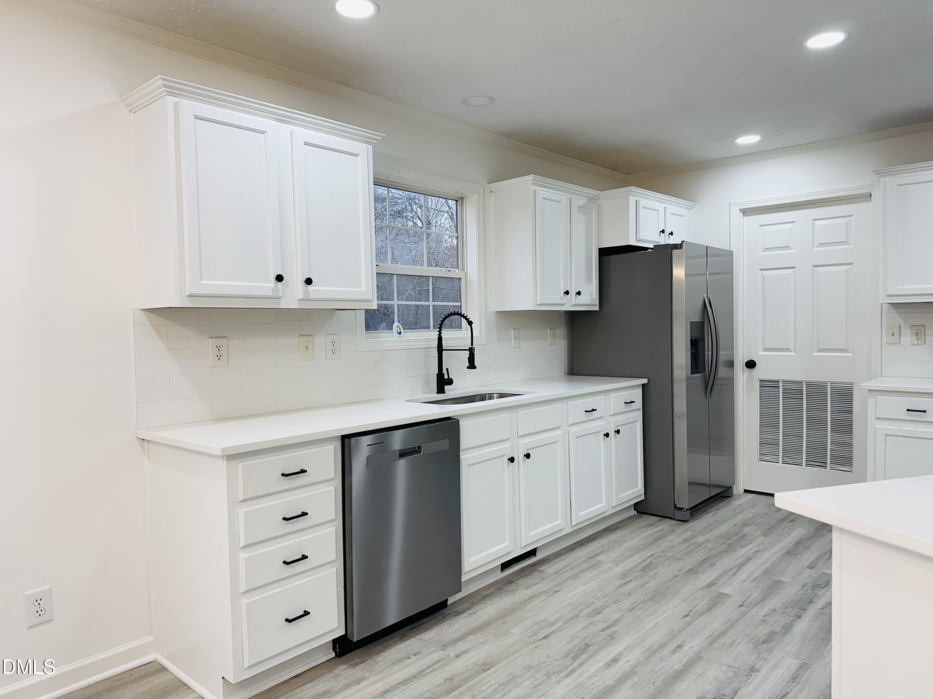 73 Christys Way Roxboro, NC 27574 - Photo 5 of 13 a kitchen with stainless steel appliances a refrigerator sink and cabinets
