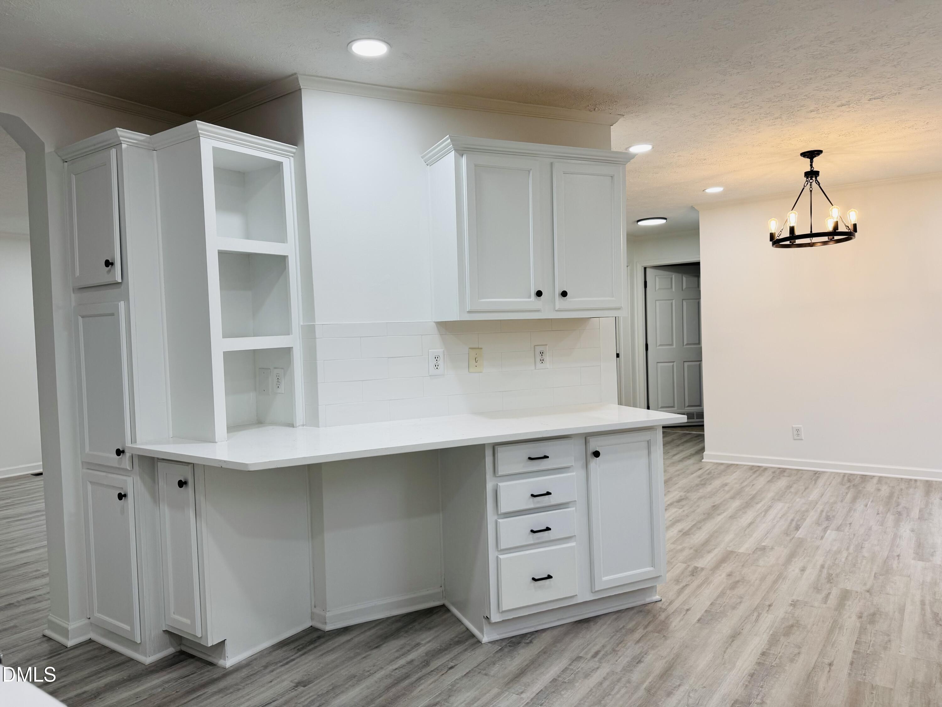73 Christys Way Roxboro, NC 27574 - Photo 6 of 13 a kitchen with a white cabinets and wooden floor