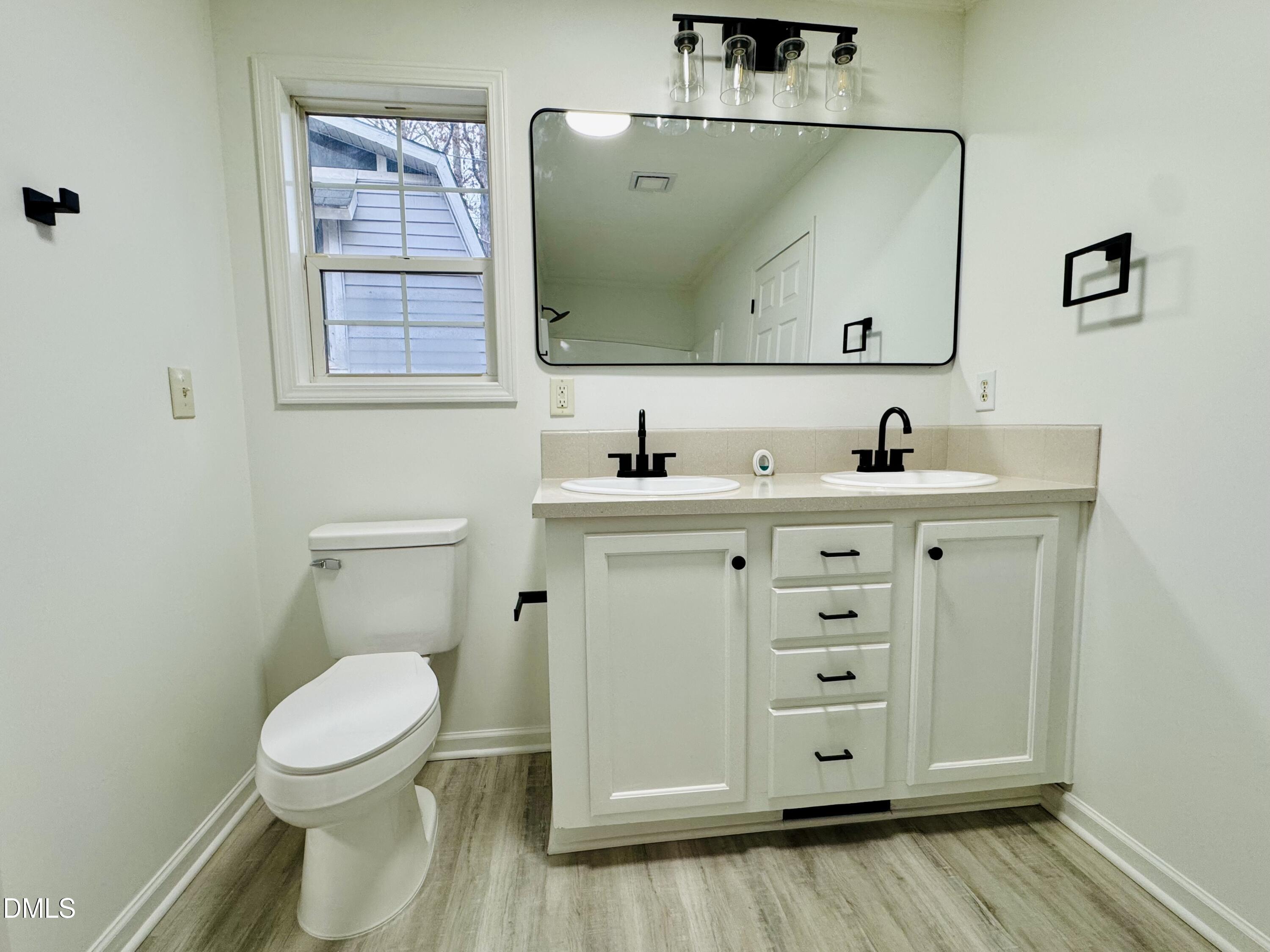 73 Christys Way Roxboro, NC 27574 - Photo 9 of 13 a bathroom with a toilet sink and mirror