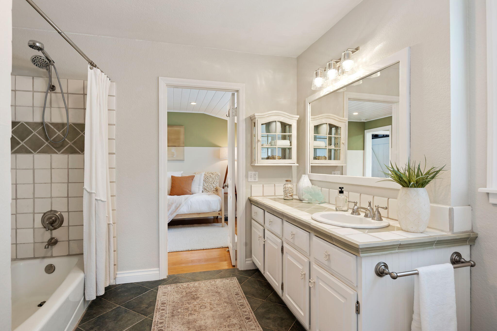 2129 Red Rose Way Santa Barbara, CA 93109 - Photo 25 of 44 a en suite bathroom with a double vanity sink a mirror and shower