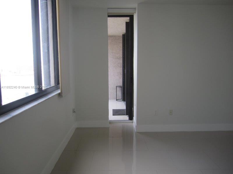 540 Brickell Key Drive, Unit 1602 Miami, FL 33131 - Photo 18 of 61 Living room side door to the balcony.