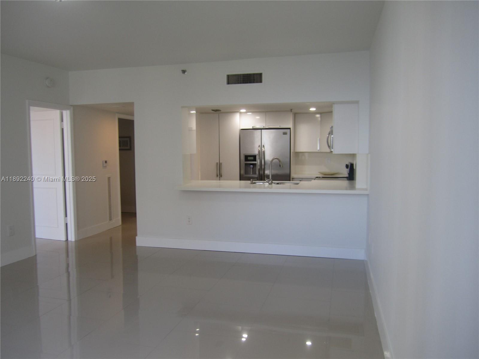 540 Brickell Key Drive, Unit 1602 Miami, FL 33131 - Photo 23 of 61 Living room over looking kitchen.