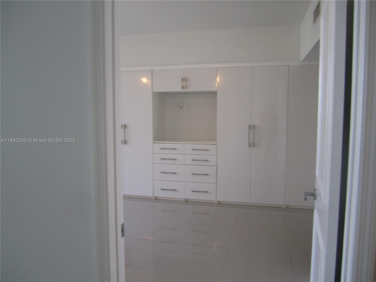 540 Brickell Key Drive, Unit 1602 Miami, FL 33131 - Photo 27 of 61 Living room looking into the bedroom.