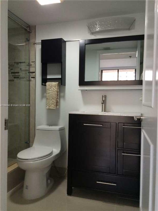 540 Brickell Key Drive, Unit 1602 Miami, FL 33131 - Photo 32 of 61 a bathroom with a toilet a sink and shower