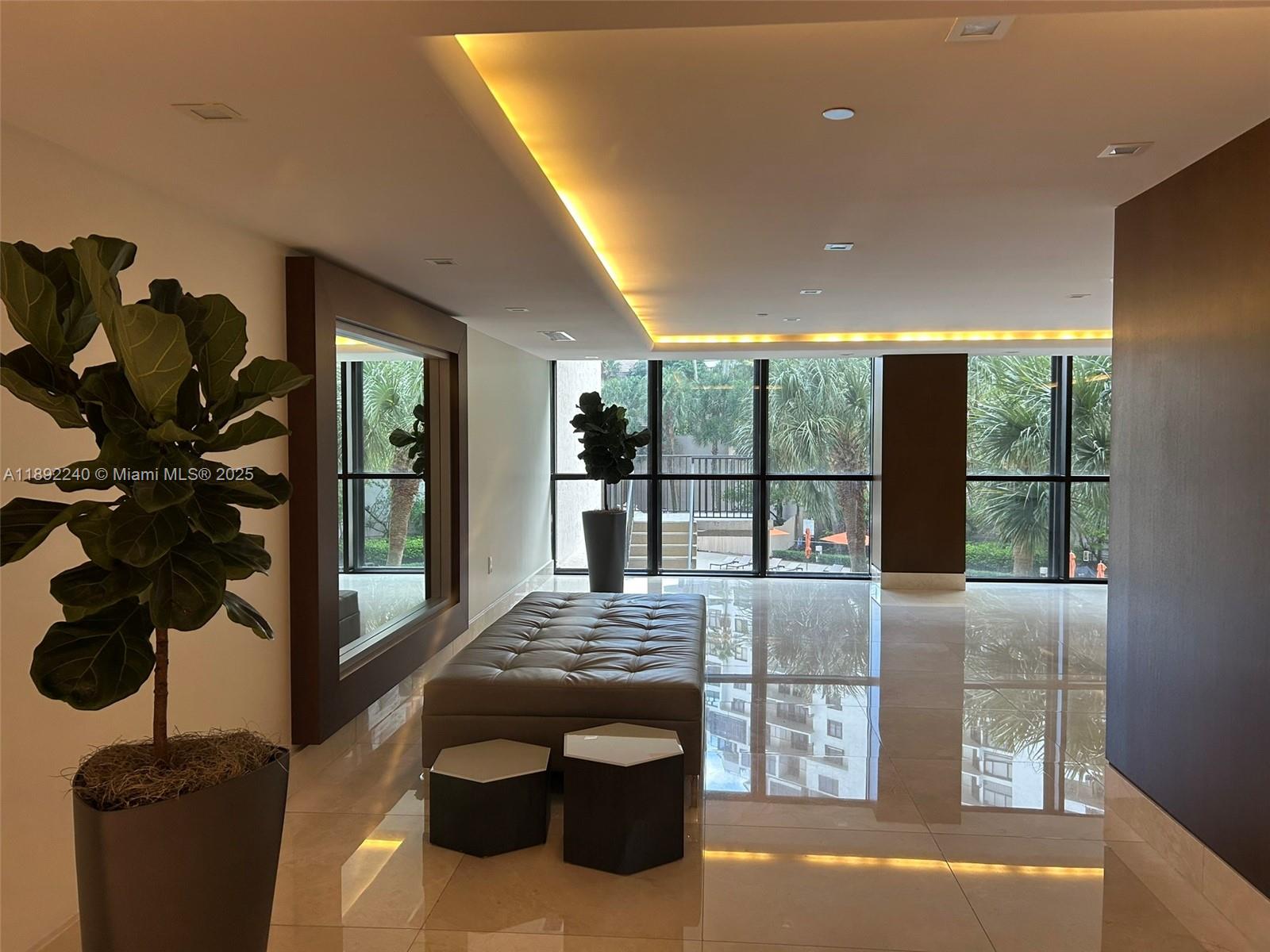 540 Brickell Key Drive, Unit 1602 Miami, FL 33131 - Photo 10 of 61 a lobby with a floor to ceiling window and a potted plant