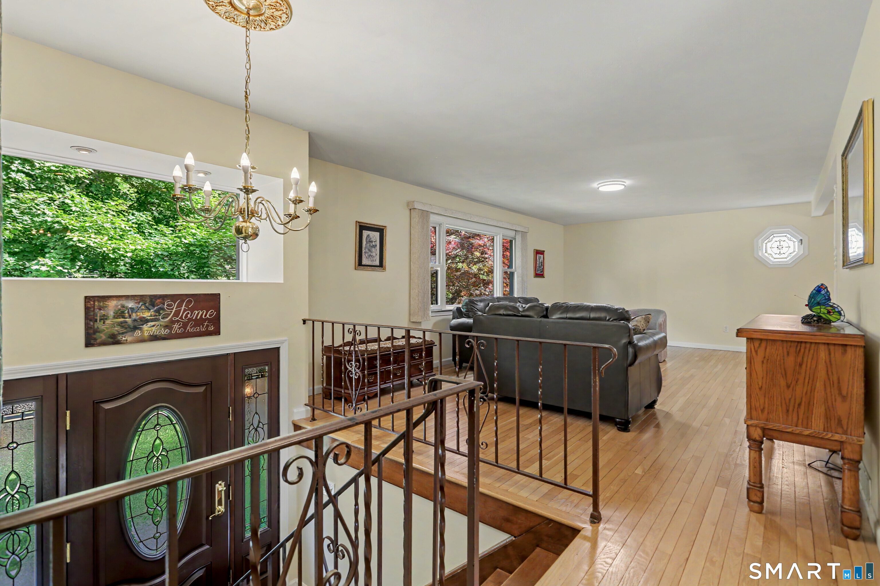 632 Wheelers Farm Road Orange, CT 06477 - Photo 4 of 39 a living room with furniture and a flat screen tv