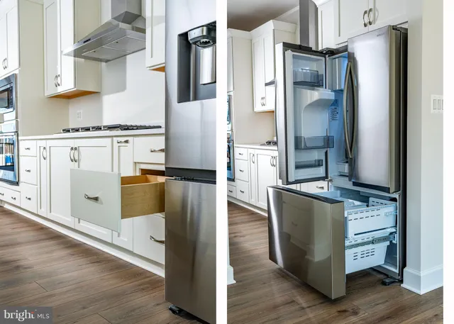 a kitchen with stainless steel appliances granite countertop a refrigerator and a stove