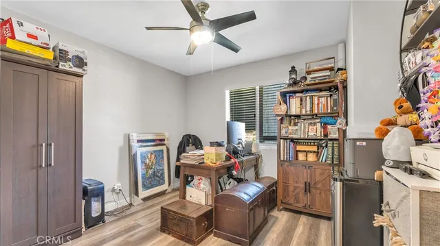 a living room with furniture a bookshelf and a window