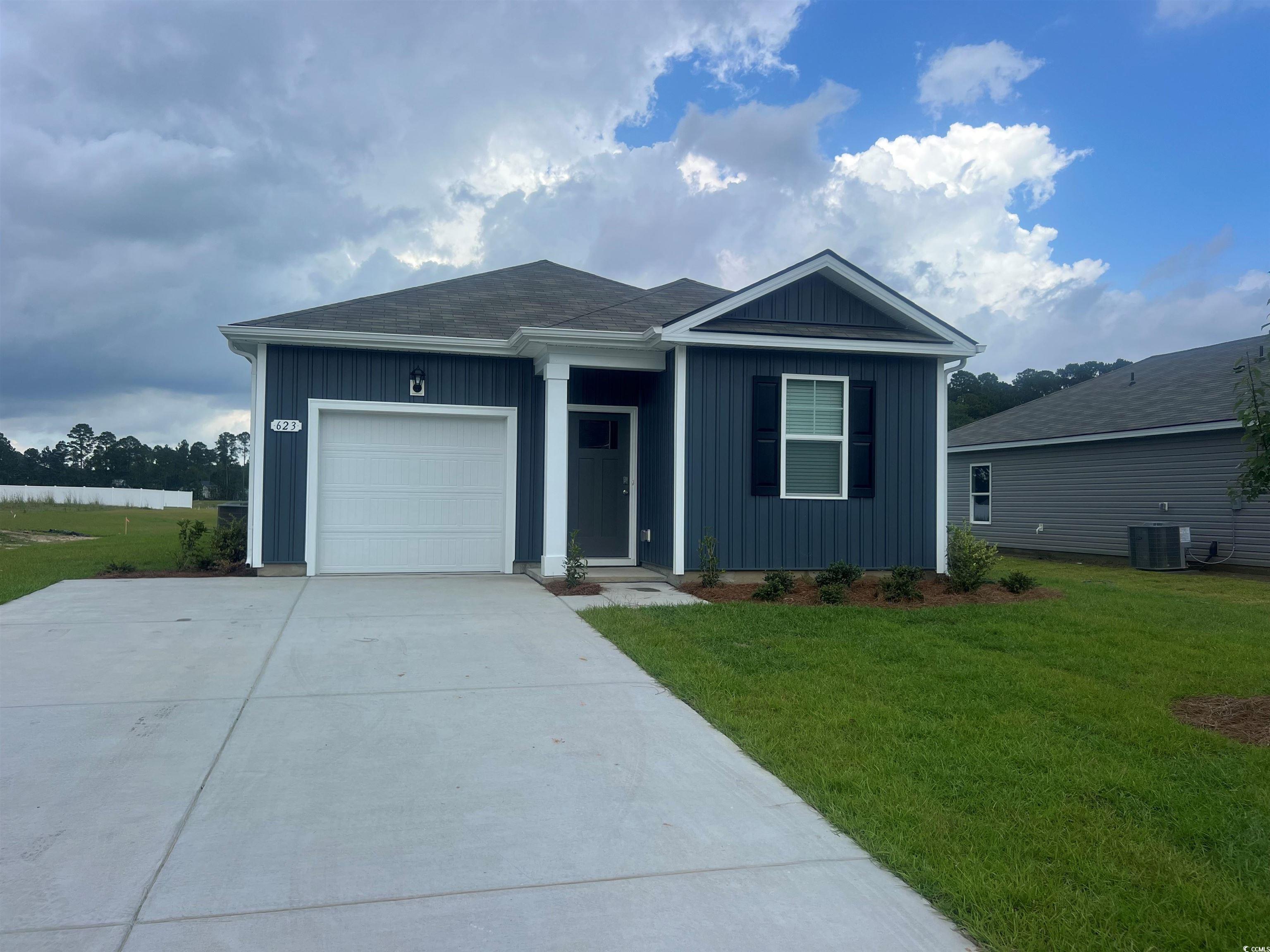 Ranch-style home with board and batten siding, con