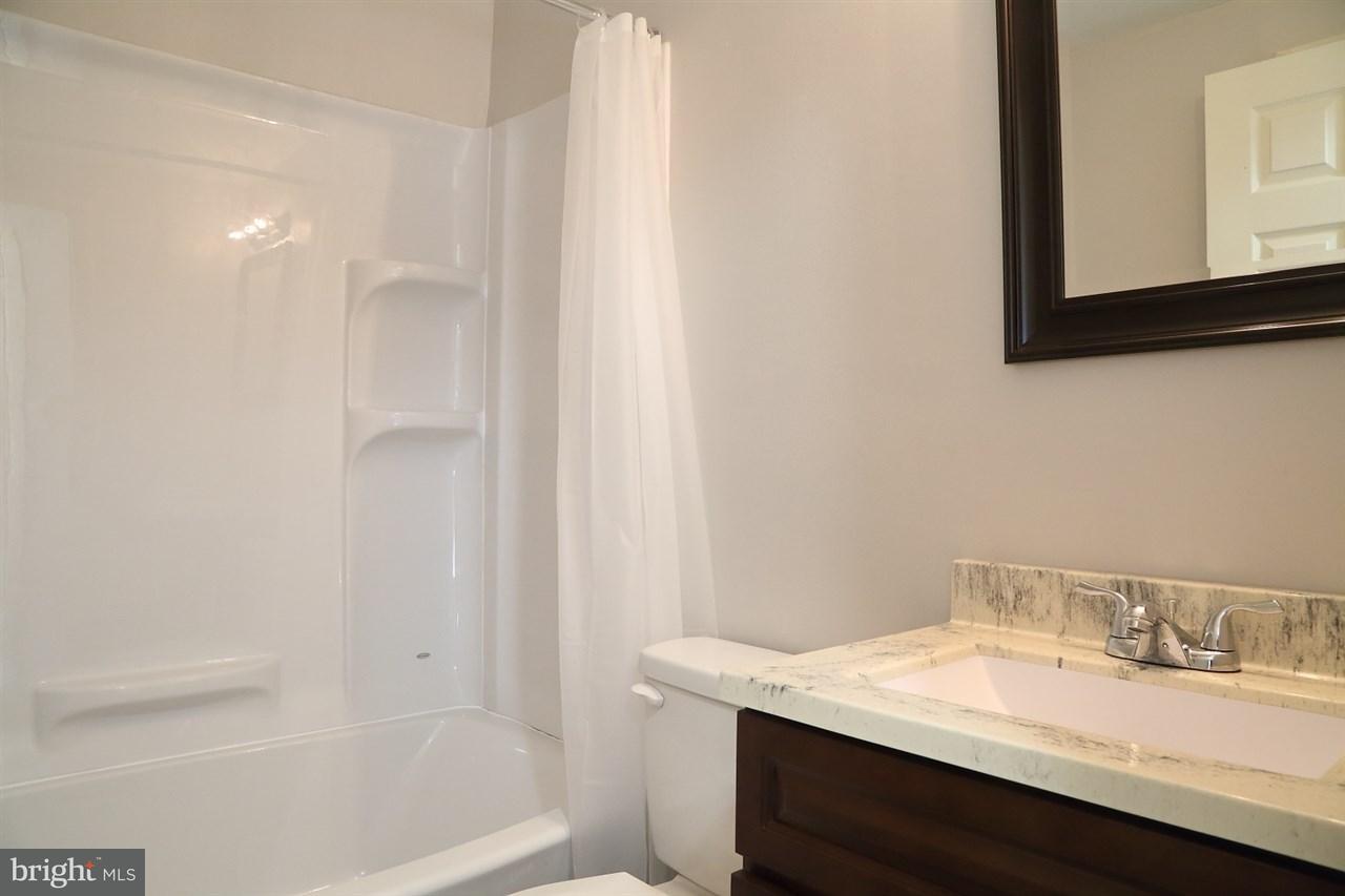 924 Hanover Road York, PA 17408 - Photo 16 of 20 a bathroom with a granite countertop sink and a mirror