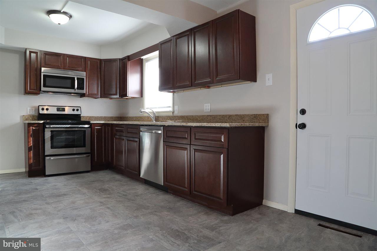 924 Hanover Road York, PA 17408 - Photo 4 of 20 a kitchen with stainless steel appliances granite countertop a stove a sink and a microwave