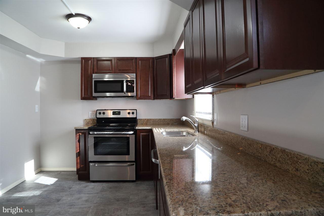 924 Hanover Road York, PA 17408 - Photo 7 of 20 a kitchen with stainless steel appliances granite countertop a stove a sink and a microwave