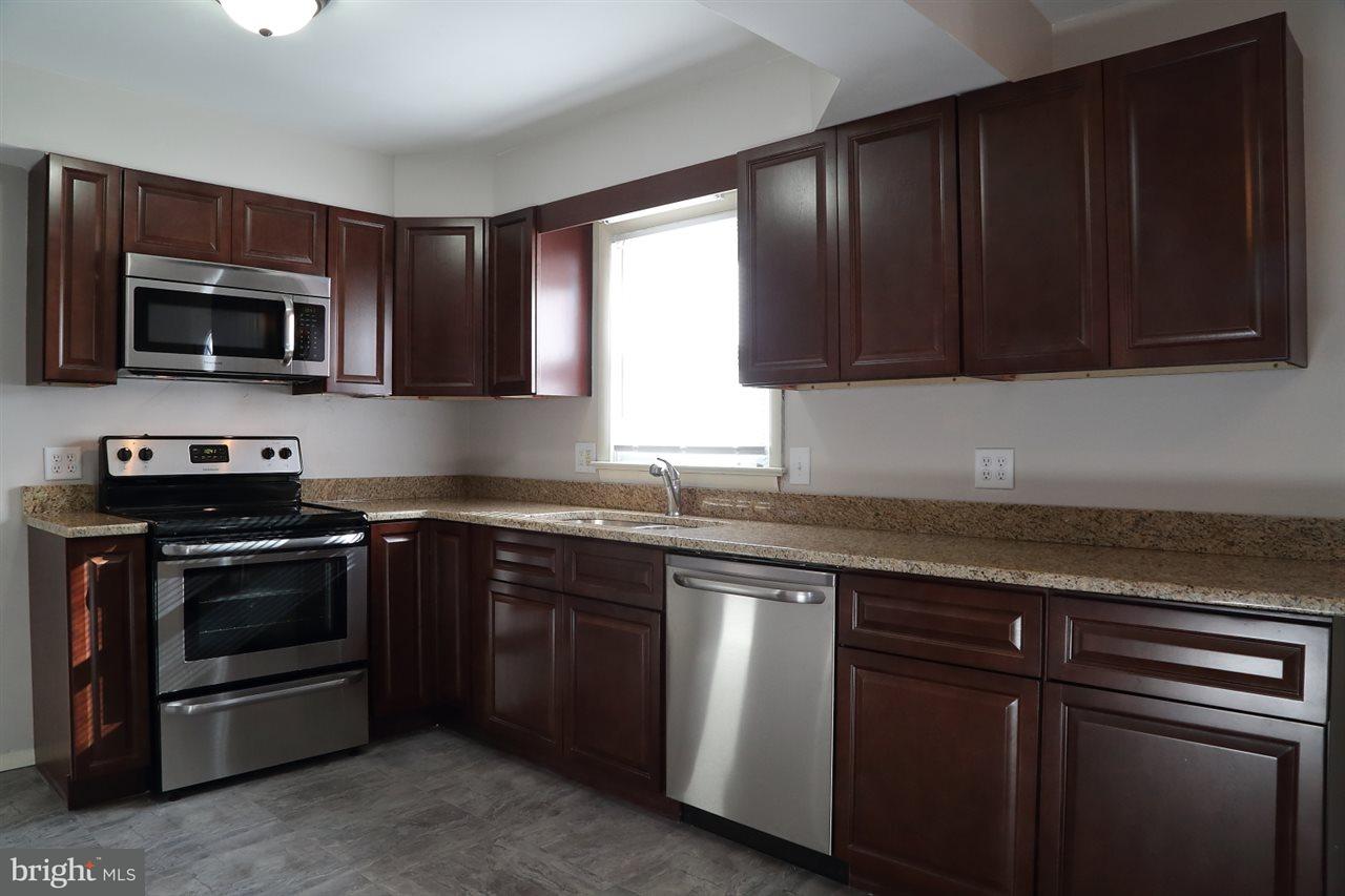924 Hanover Road York, PA 17408 - Photo 8 of 20 a kitchen with granite countertop wooden cabinets and stainless steel appliances