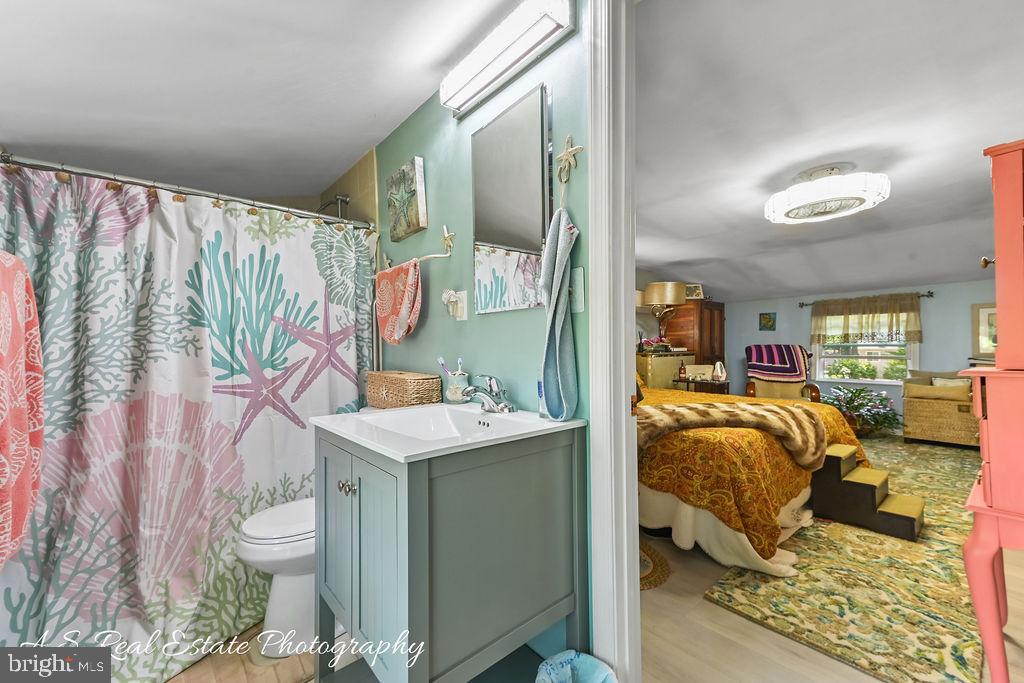 122 Sandyhook Road Ocean Pines, MD 21811 - Photo 14 of 16 a bedroom with a bed and a table