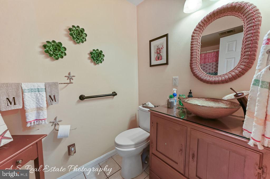 122 Sandyhook Road Ocean Pines, MD 21811 - Photo 16 of 16 a bathroom with a toilet a sink and mirror