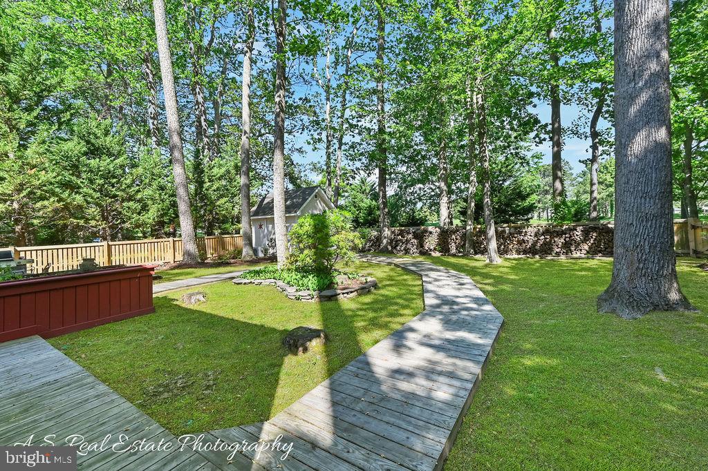 122 Sandyhook Road Ocean Pines, MD 21811 - Photo 4 of 16 a view of a backyard with large trees