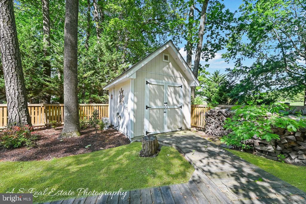 122 Sandyhook Road Ocean Pines, MD 21811 - Photo 5 of 16 a view of backyard with small garden and outdoor seating