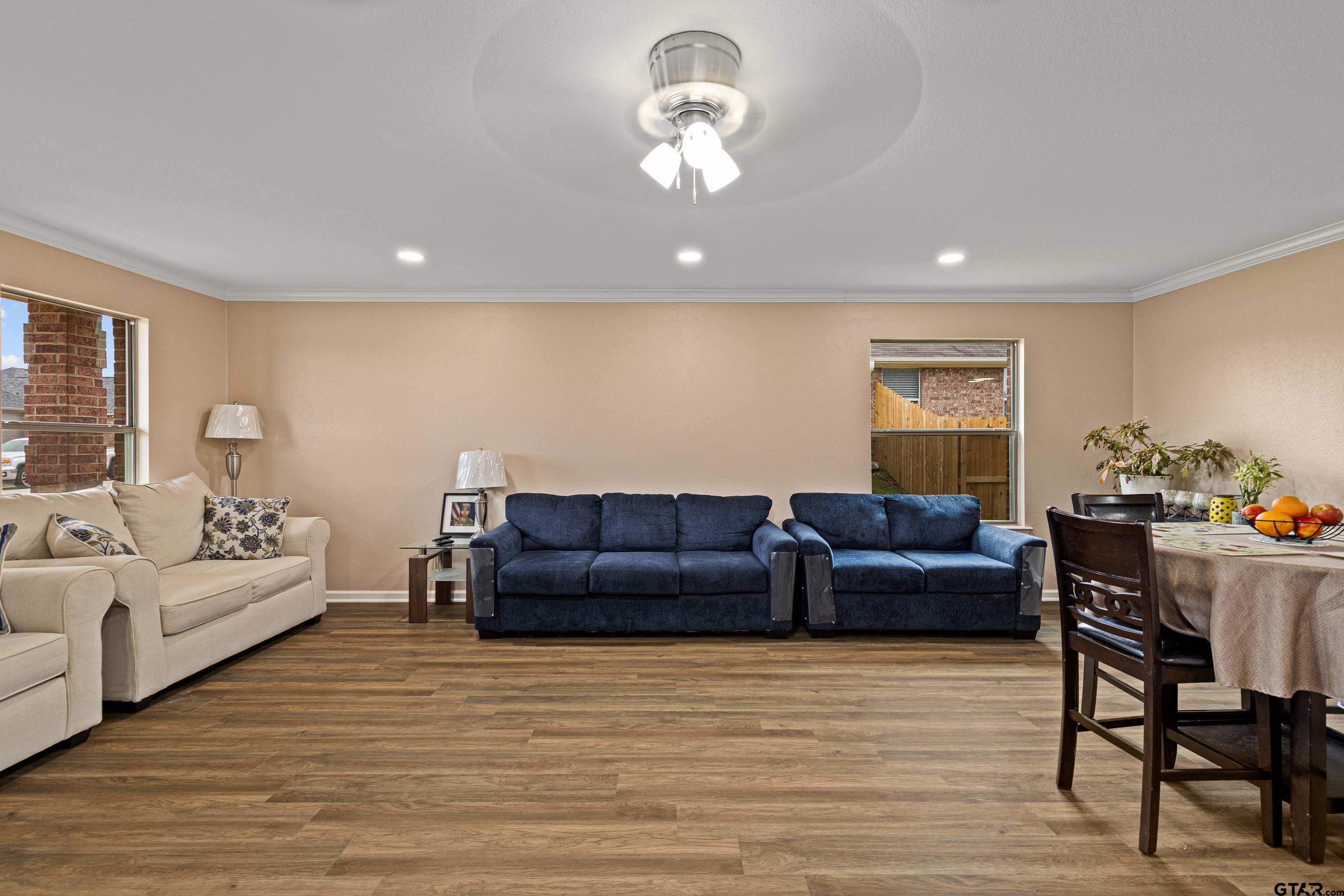553 Princess Place Tyler, TX 75704 - Photo 16 of 32 a living room with furniture and a wooden floor