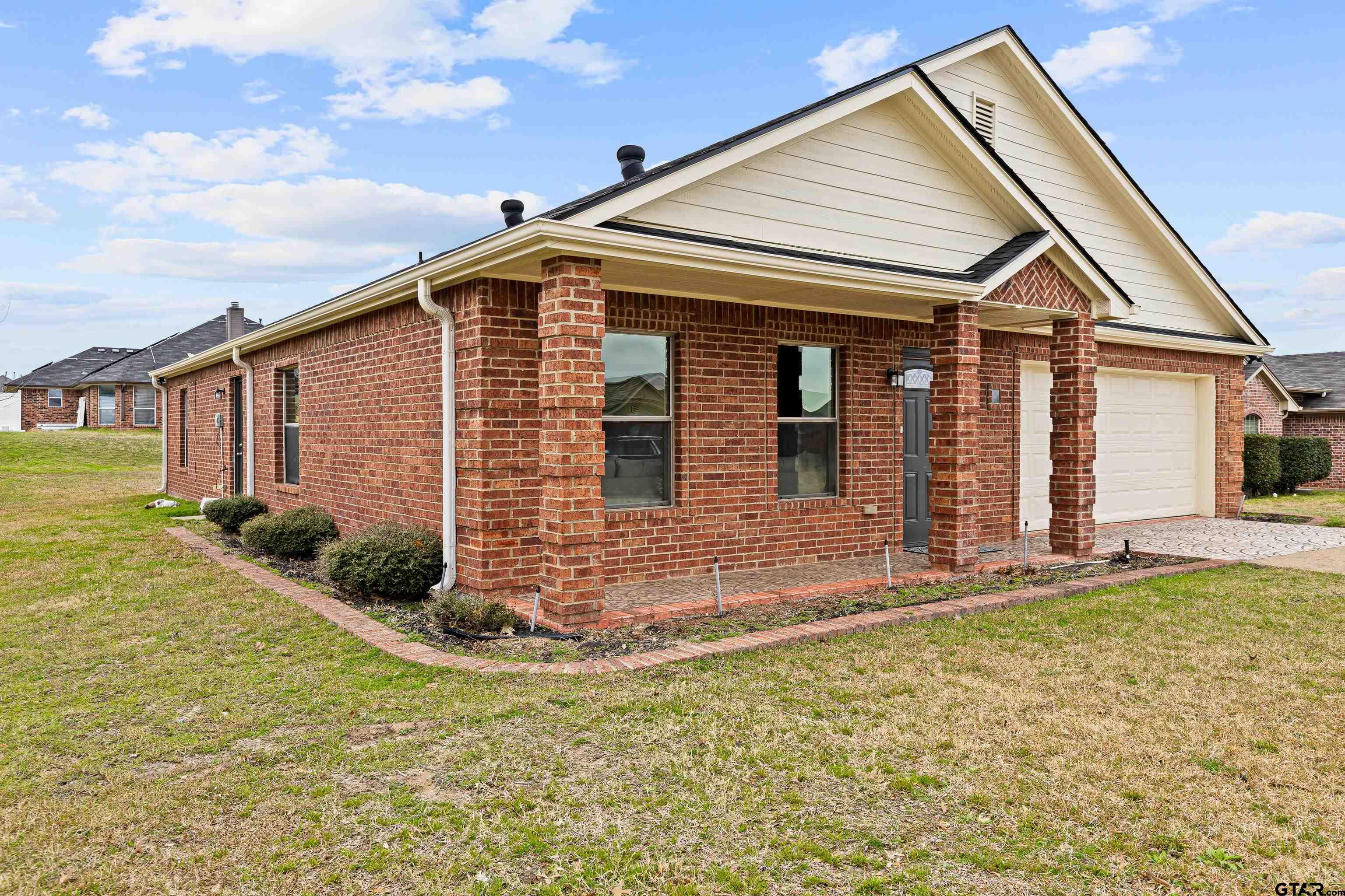 553 Princess Place Tyler, TX 75704 - Photo 24 of 32 a front view of a house with garden
