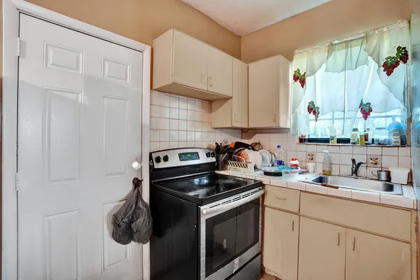 a kitchen with a sink stove and cabinets