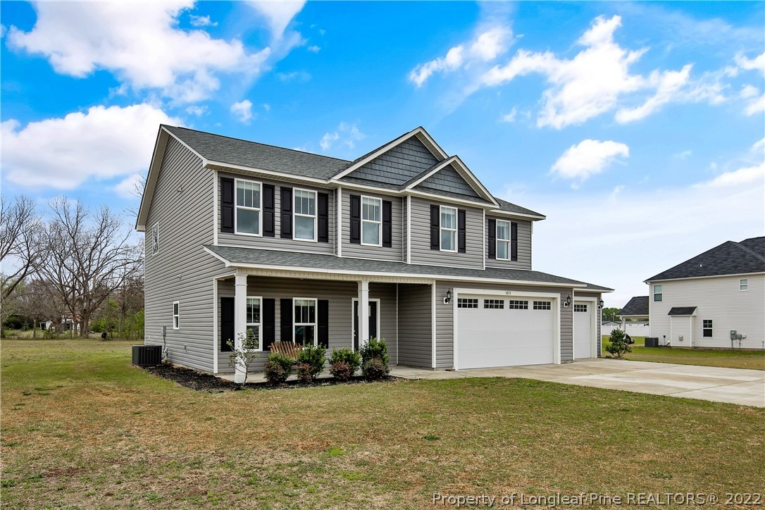 5213 Bree Bridge Road Hope Mills, NC 28348 - Photo 2 of 50 a front view of a house with a garden and yard
