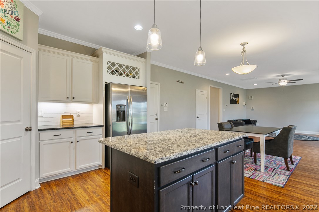 5213 Bree Bridge Road Hope Mills, NC 28348 - Photo 22 of 50 a kitchen with a stove a refrigerator and a kitchen island