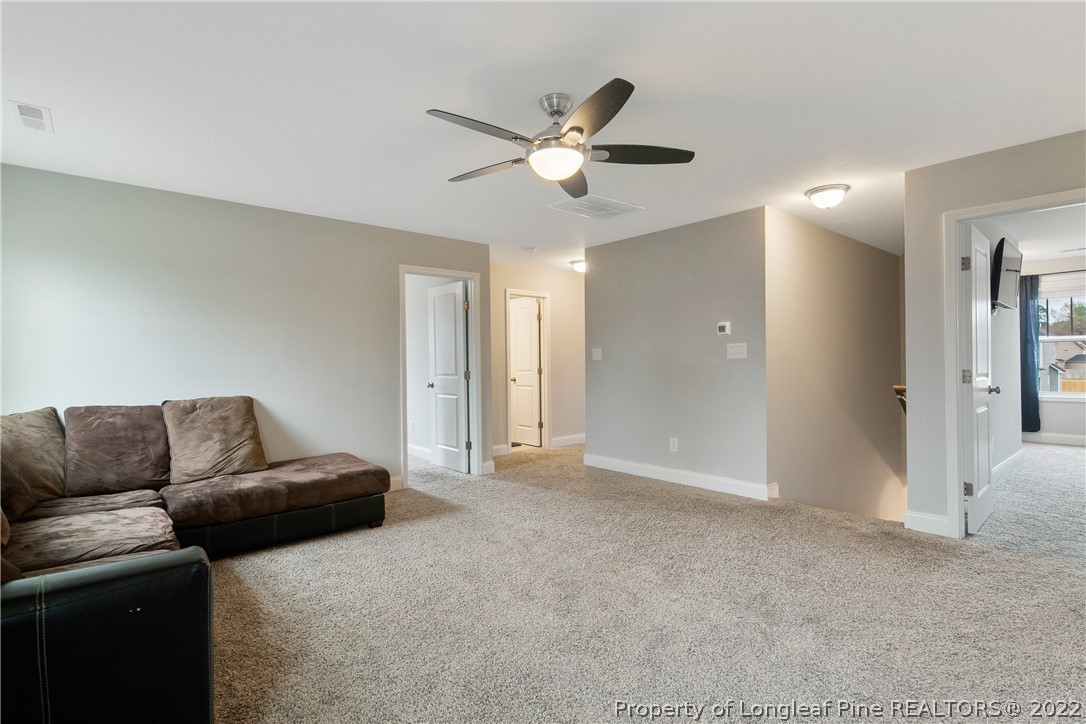 5213 Bree Bridge Road Hope Mills, NC 28348 - Photo 24 of 50 a living room with furniture and a ceiling fan