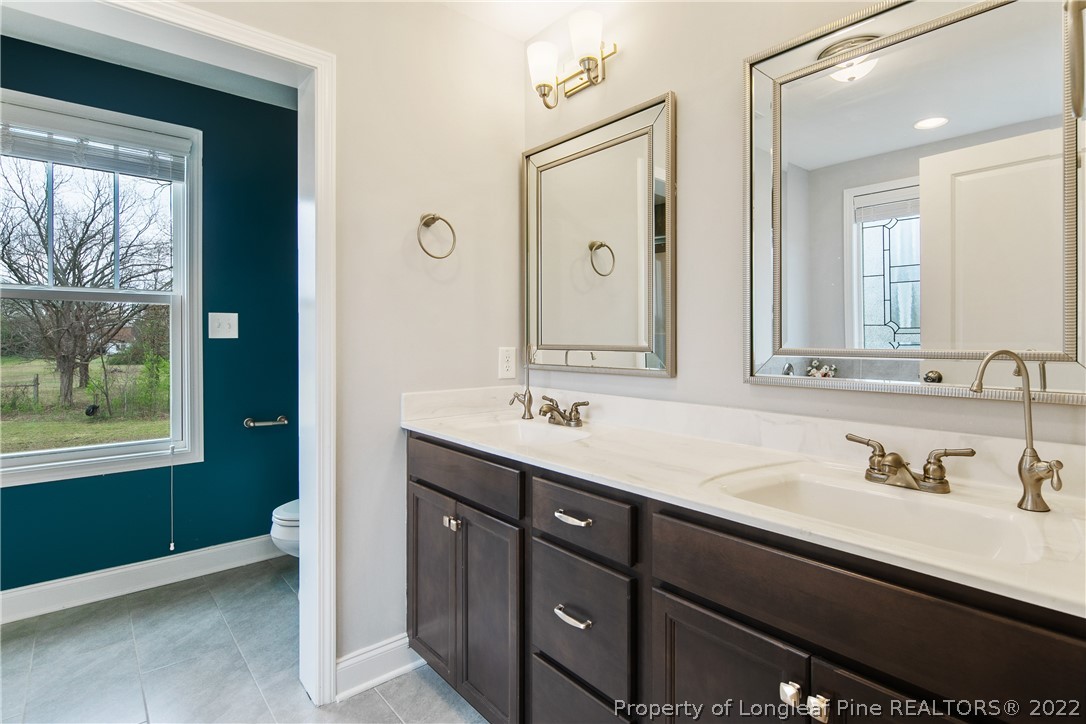5213 Bree Bridge Road Hope Mills, NC 28348 - Photo 32 of 50 a bathroom with a sink and a mirror