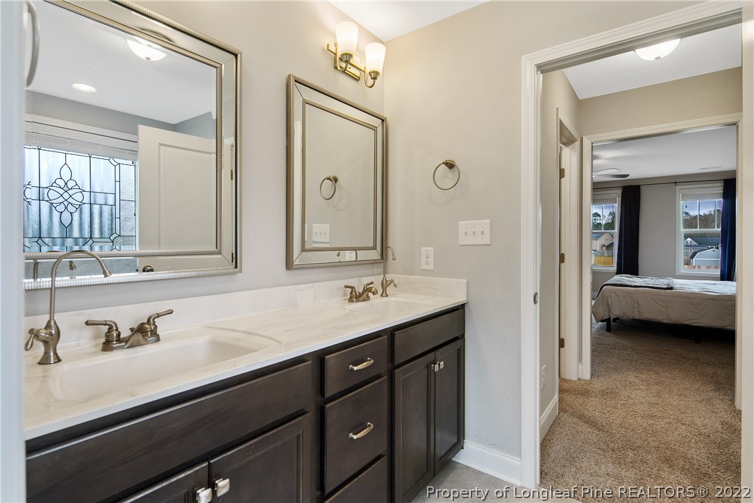 5213 Bree Bridge Road Hope Mills, NC 28348 - Photo 33 of 50 a en suite bathroom with a sink double vanity and a mirror