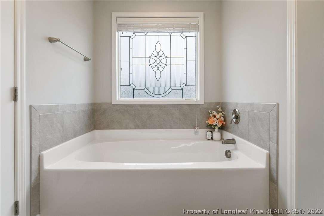 5213 Bree Bridge Road Hope Mills, NC 28348 - Photo 35 of 50 a white bath tub sitting in a bathroom next to a window