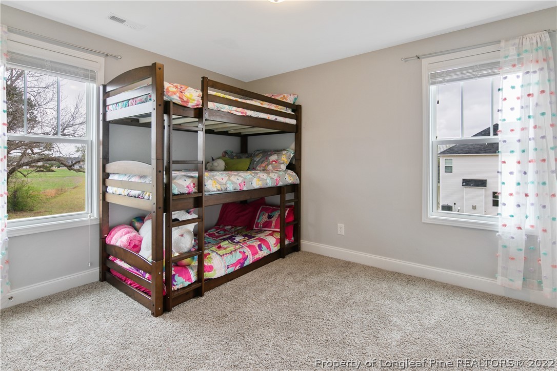 5213 Bree Bridge Road Hope Mills, NC 28348 - Photo 36 of 50 a bedroom with a bed and a window