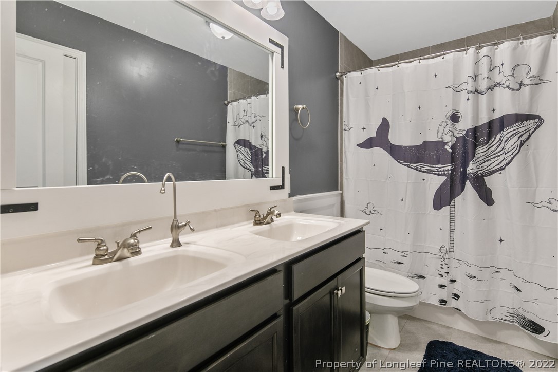 5213 Bree Bridge Road Hope Mills, NC 28348 - Photo 39 of 50 a bathroom with a sink toilet and a mirror