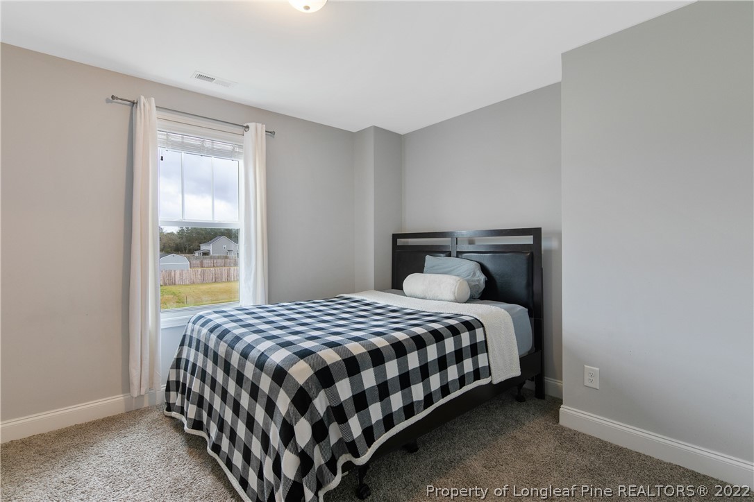 5213 Bree Bridge Road Hope Mills, NC 28348 - Photo 45 of 50 a bedroom with a bed and window