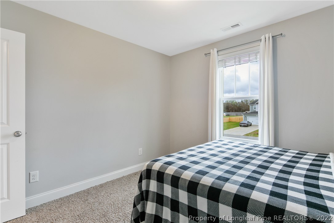 5213 Bree Bridge Road Hope Mills, NC 28348 - Photo 47 of 50 a bedroom with a bed and a window