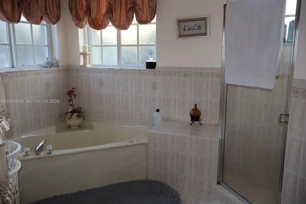 a bathroom with a bathtub and window
