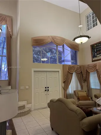 a living room with furniture and a ceiling fan