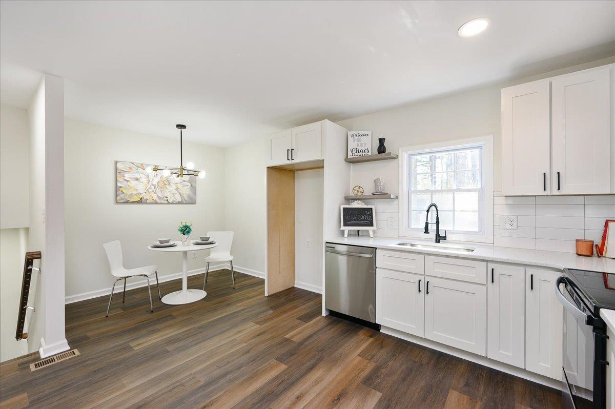 5506 McCormick Road Durham, NC 27713 - Photo 12 of 28 a kitchen with a sink cabinets and wooden floor