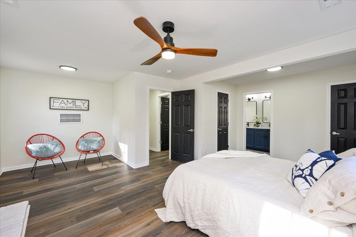 5506 McCormick Road Durham, NC 27713 - Photo 18 of 28 a bedroom with a bed and a chandelier