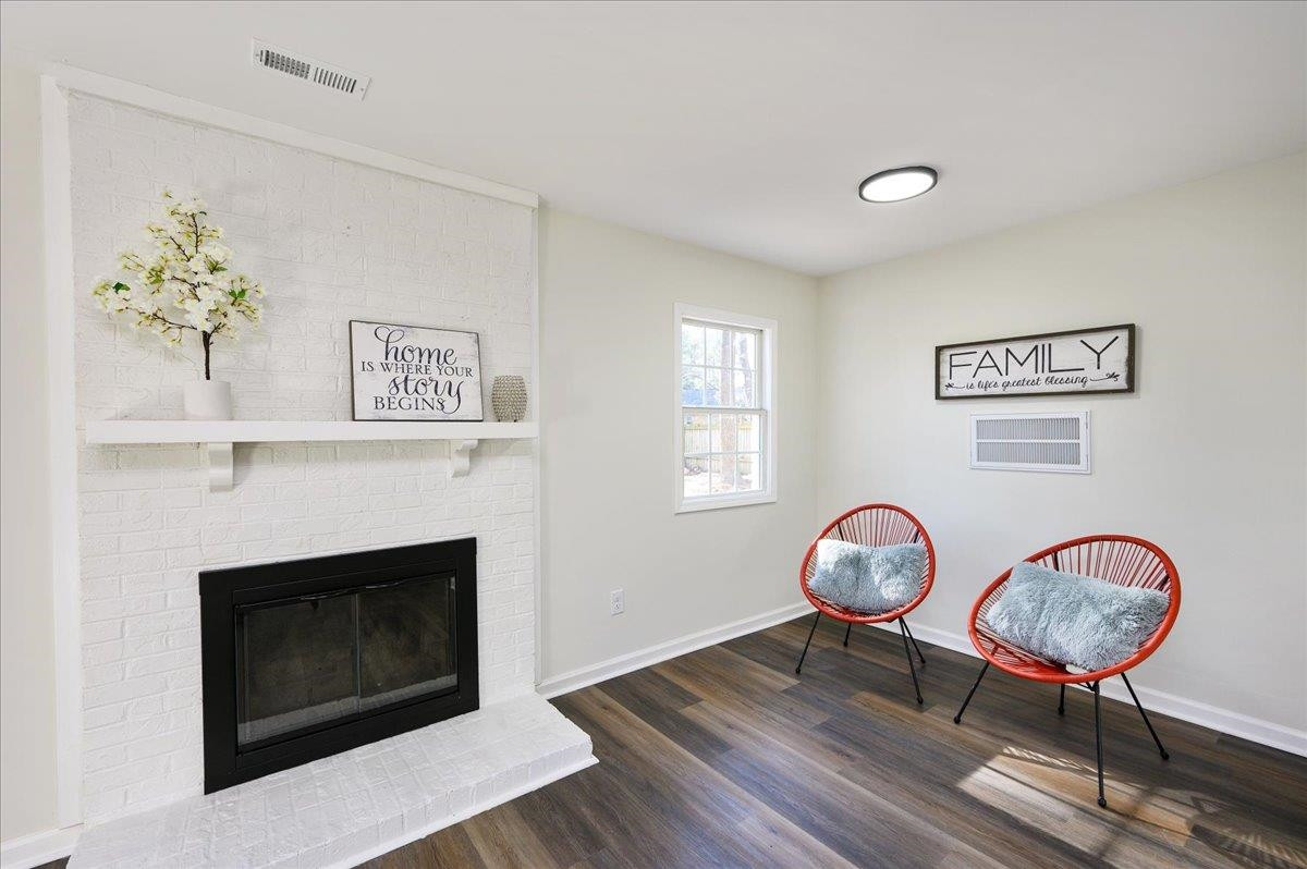 5506 McCormick Road Durham, NC 27713 - Photo 19 of 28 a view of a livingroom with furniture a fireplace chandeliers fan