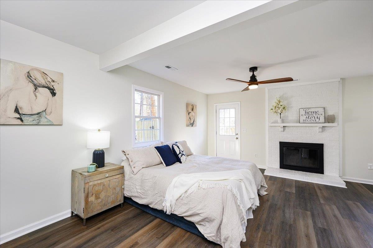 5506 McCormick Road Durham, NC 27713 - Photo 20 of 28 a bedroom with a bed and a fireplace