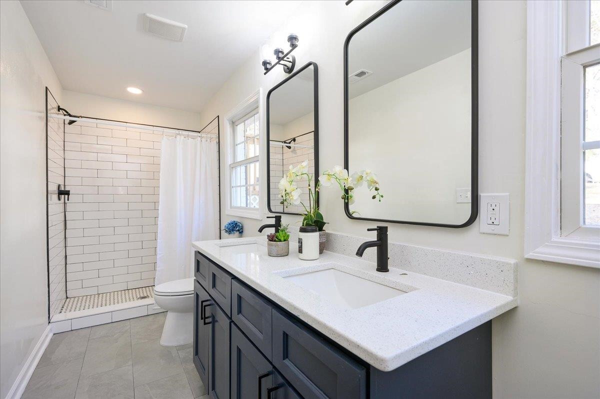 5506 McCormick Road Durham, NC 27713 - Photo 21 of 28 a bathroom with a sink and a mirror