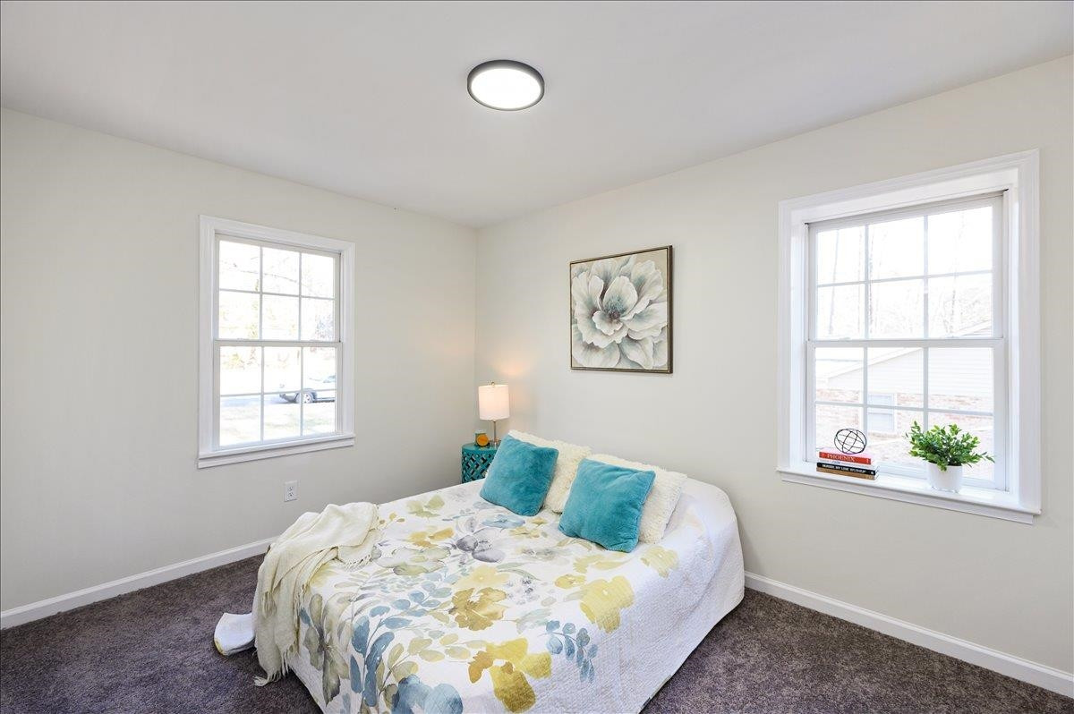 5506 McCormick Road Durham, NC 27713 - Photo 27 of 28 a bed sitting in a bedroom next to a window