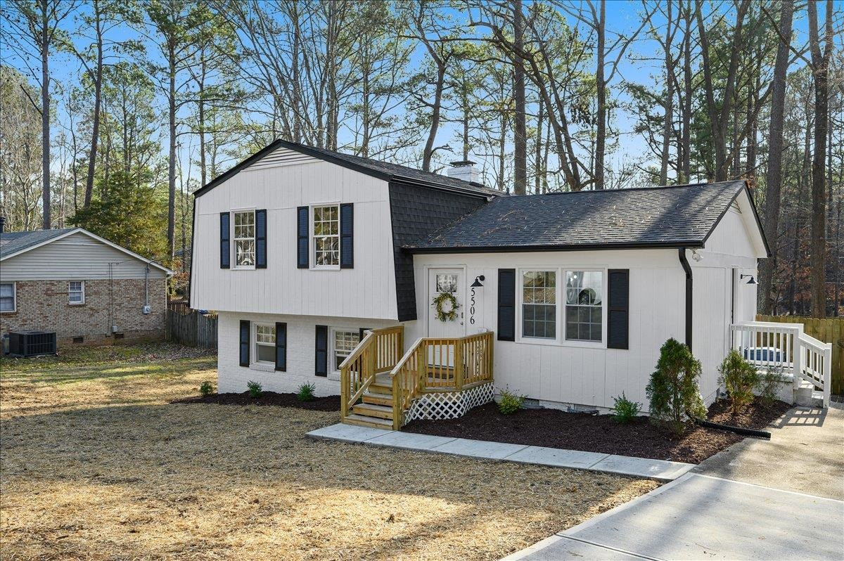 5506 McCormick Road Durham, NC 27713 - Photo 3 of 28 a front view of a house with a yard garage and outdoor seating