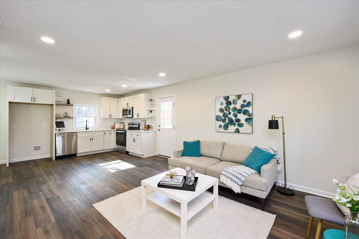 5506 McCormick Road Durham, NC 27713 - Photo 8 of 28 a living room with furniture and a wooden floor