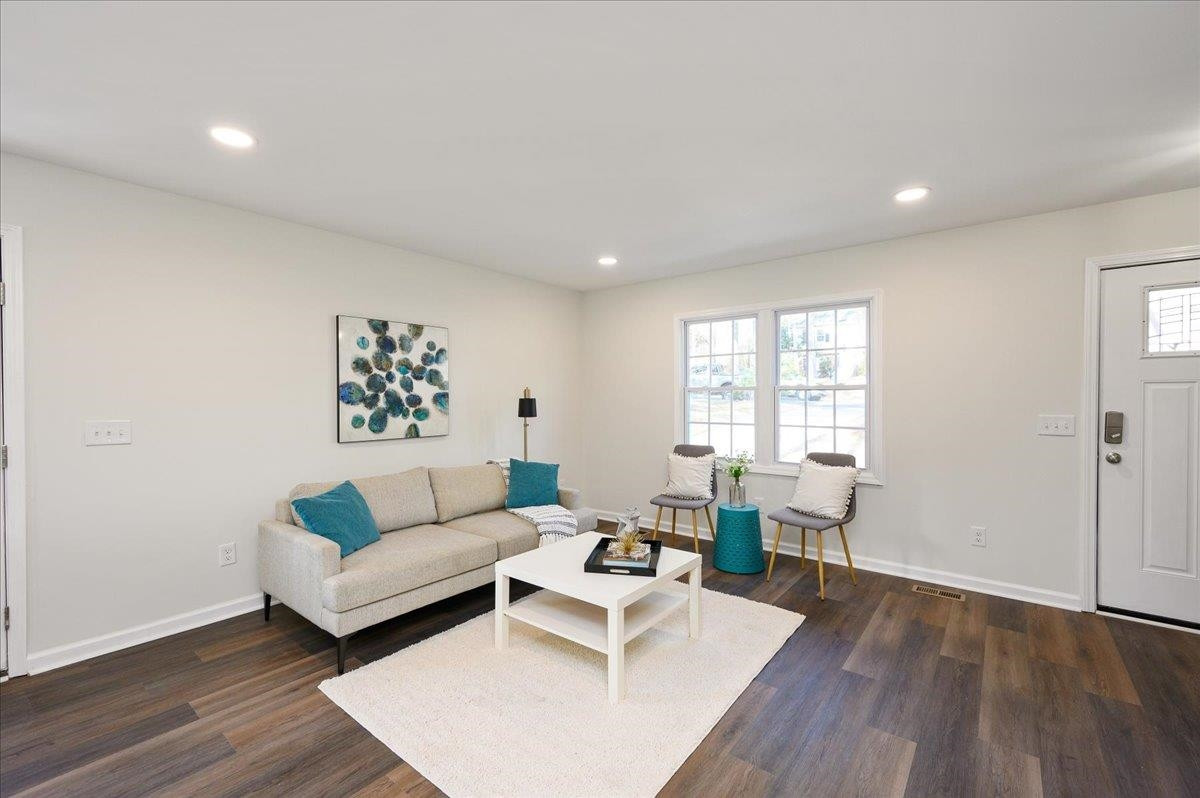 5506 McCormick Road Durham, NC 27713 - Photo 10 of 28 a living room with furniture and a wooden floor