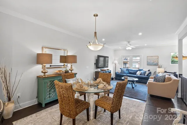 a view of a dining room with furniture and a chandelier
